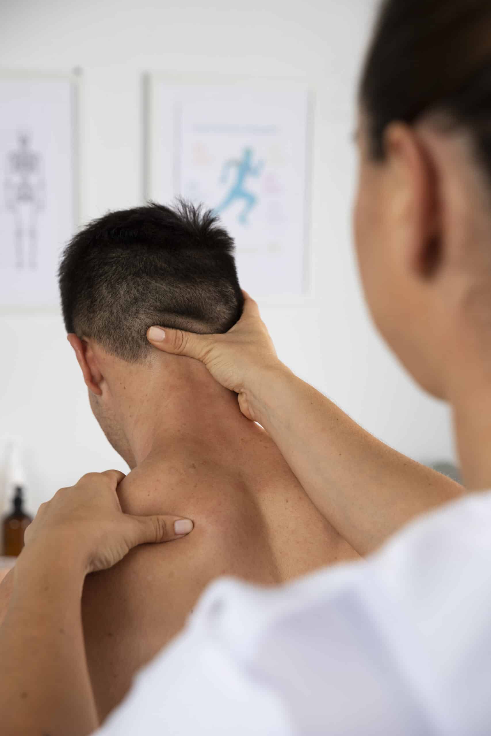 physiotherapist-performing-therapeutic-massage-male-client